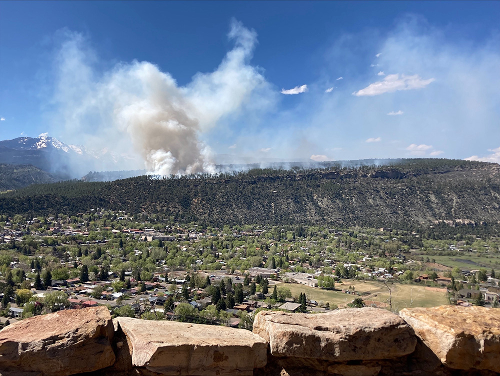 aerial view of Animas City with fire burning in distance