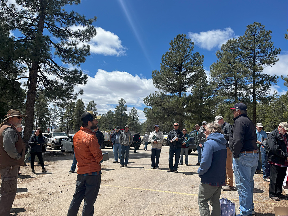 group of people standing in summit lake parking lot